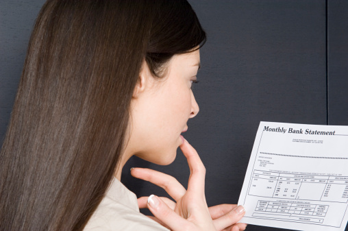 Woman looking at bank statement